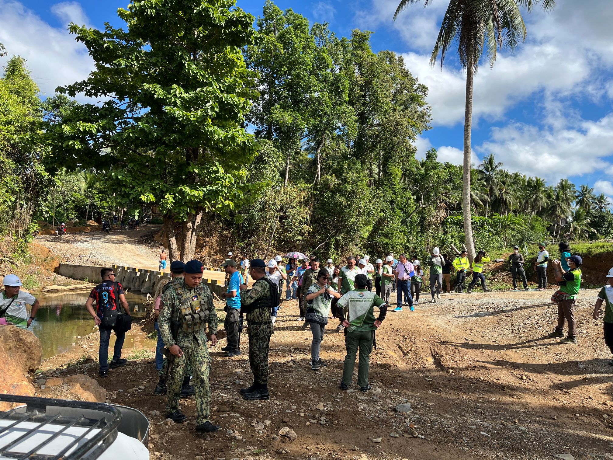 Community members gathered outdoors near the project area